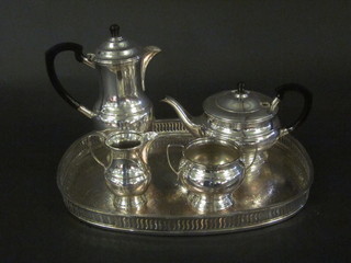 An oval engraved silver tea tray with pierced gallery together  with a 4 piece silver plated tea service comprising teapot,  hotwater jug, lid f, sugar bowl and cream jug,