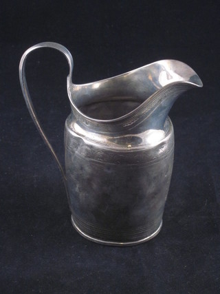 A Georgian silver cream jug with bright cut decoration, marks rubbed 3 1/2 ozs