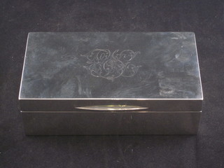 A silver cigarette box with solid hinged lid, London 1920, 6 1/2"