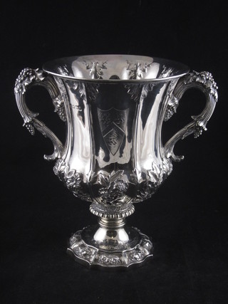 A George IV embossed silver twin handled cup with armorial decoration, London 1812 by Rebecca and Edward Barnard Emes,  28 ozs  ILLUSTRATED