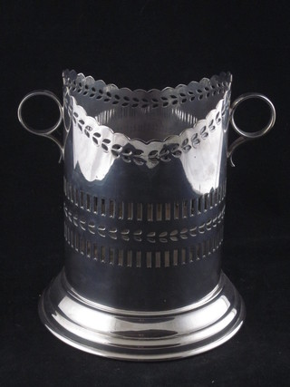 A cylindrical pierced silver plated twin handled soda siphon holder