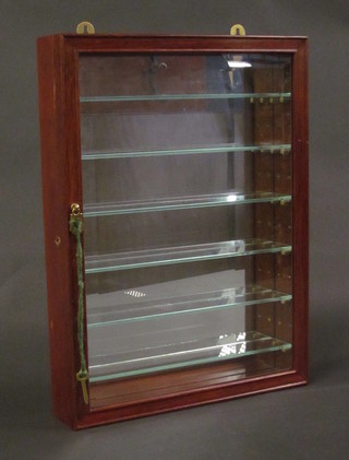An Oriental hardwood hanging display cabinet with mirrored  back, fitted shelves and enclosed by a glazed bevelled panelled  door 15"