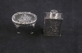 A Dutch embossed silver caddy decorated romantic scenes 1" and  a circular miniature silver table decorated romantic scenes 2"