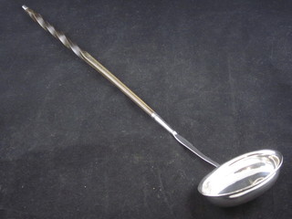 A silver ladle with whalebone twist handle