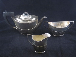 A Victorian oval silver 3 piece Bachelor's tea service comprising teapot, cream jug and sugar bowl, Chester marks rubbed, 12  1/2 ozs