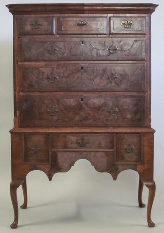 A Queen Anne walnut chest on stand, the upper section with moulded cornice fitted 3 short drawers above 3 long drawers with  brass plate drop handles, the base fitted 1 long and 2 short  drawers, raised on cabriole supports 42"   ILLUSTRATED