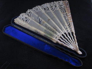 A Victorian fan with mother of pearl sticks, contained in a  leather case