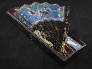 An Oriental lacquered fan with painted panels contained in a lacquered box