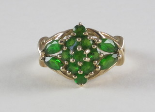 A gold cluster dress ring ring set emeralds