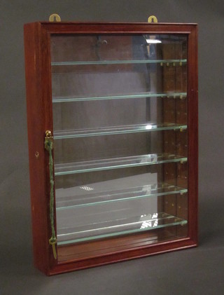 An Oriental hardwood display cabinet with mirrored back, fitted shelves enclosed by a glazed bevelled panelled door 15"