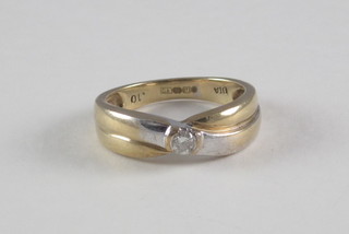 A 9ct two coloured gold dress ring set a diamond