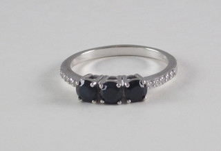 A 9ct white gold dress ring set 3 sapphires with diamonds to the shoulders