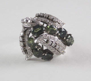 A lady's 14ct white gold dress ring set emeralds and diamonds