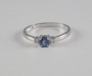 A 9ct white gold dress ring set a tanzanite surrounded by  diamonds
