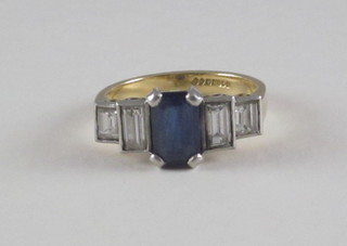 A lady's 18ct yellow gold dress/engagement ring set a  rectangular blue sapphire supported by 4 rectangular cut diamonds