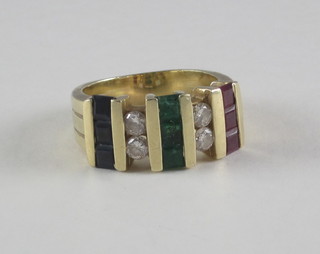 A gold dress ring set rubies, emeralds, sapphires and diamonds