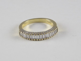 An 18ct yellow gold half eternity dress ring set baguette cut  diamonds