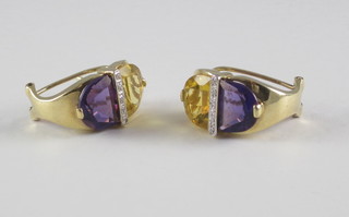 A pair of 14ct gold earrings set amethysts, diamonds and yellow stones