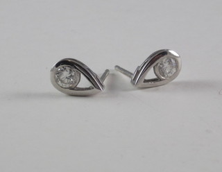 A pair of white gold tear drop shaped earrings set diamonds
