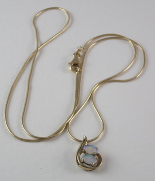 A fine gold chain hung a 9ct gold pendant set an opal