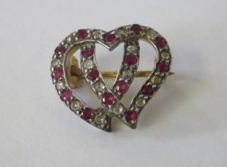 A gold brooch in the form of 2 entwined hearts set rubies and diamonds