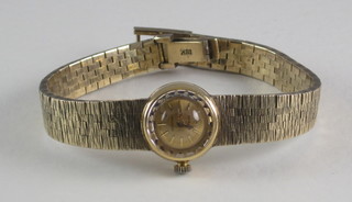 A lady's Rolex wristwatch contained in an 18ct gold case with integral bracelet