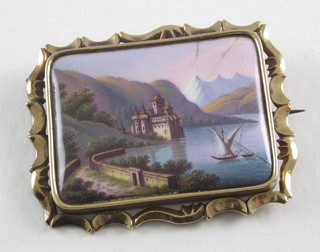 A Victorian rectangular enamelled brooch decorated a landscape contained in a gilt metal mount
