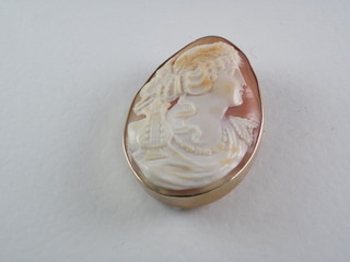 A shell carved cameo brooch contained in a gold mount
