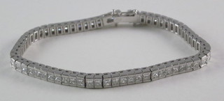 An 18ct white gold bracelet set square Princess cut diamonds, approx 8ct