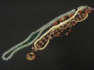 A string of ivory beads, a string of jade type beads, a string of hardstone beads and a string of enamelled beads