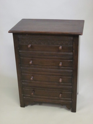 A carved oak chest of 4 long drawers with tore handles 27"