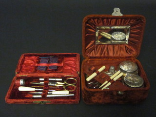 A brown plush case with hinged lid, containing 2 circular  dressing table jars with silver lids, a small easel photograph frame, a silver thimble, 3 ivory sewing implements and a plush  case containing a manicure set