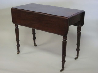 A Victorian mahogany Pembroke table fitted a drawer and raised  on turned supports 35"