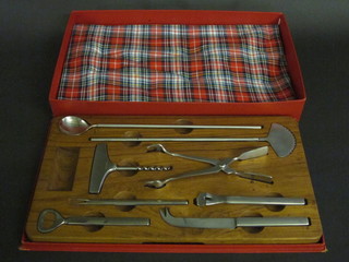 A Georg Jensen cocktail set comprising corkscrew, cheese knife and 6 other implements, cased
