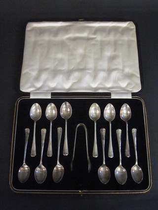 A set of 12 silver Old English rat tail pattern coffee spoons  complete with tongs, Sheffield 1939, 6 ozs, cased