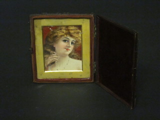 A portrait miniature print of a girl contained in a square leather  case 3" x 3"