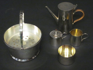 A circular silver plated ice pail and a 4 piece silver plated coffee service and a spirit burner