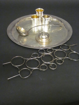 A circular silver plated platter, an old English pattern soup ladle  etc