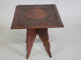 A square Oriental carved hardwood occasional table, raised on a folding stand 18"