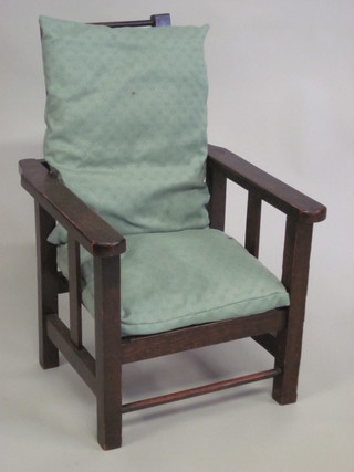 A childs 1930's oak framed reclining armchair