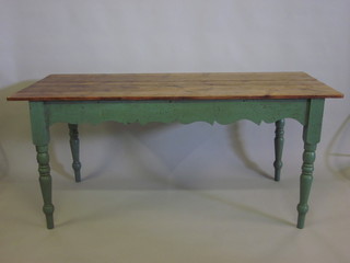 A rectangular pine and green painted kitchen table with wavy  apron raised on turned supports 67"