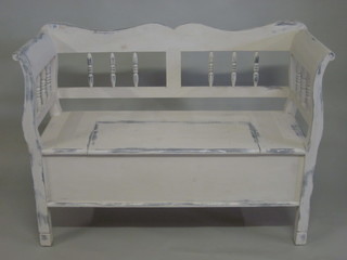 A white painted pine settle with bobbin turned decoration 49"