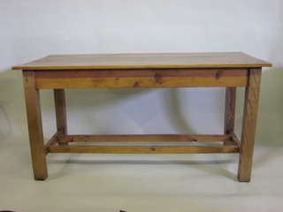 A rectangular pine table with panelled top, raised on square supports with H framed stretcher 60"