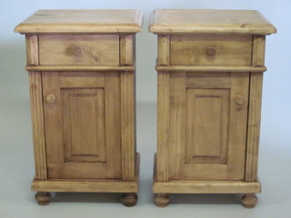 A pair of pine bedside cabinets, fitted a drawer above a  cupboard 17"