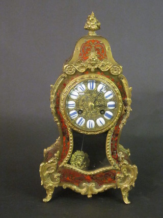 A 19th Century French 8 day striking mantel clock contained in a shaped red boulle case with Roman numerals   ILLUSTRATED