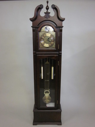 A 31 day striking longcase clock by C Wood & Sons, with 9  1/2" arched dial, contained in a mahogany case 77"