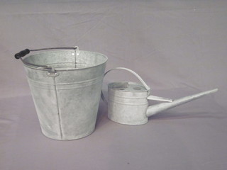 A galvanised pail and a watering can