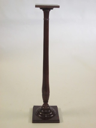A Victorian turned and reeded mahogany torchere