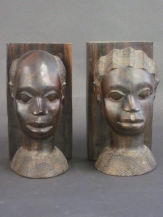 A pair of African carved wooden bookends in the form of portrait  busts 8"