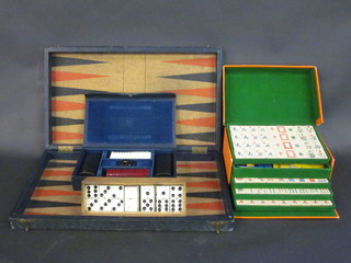 A Backgammon set, a plastic Mahjong set and a set of dominoes,  all boxed